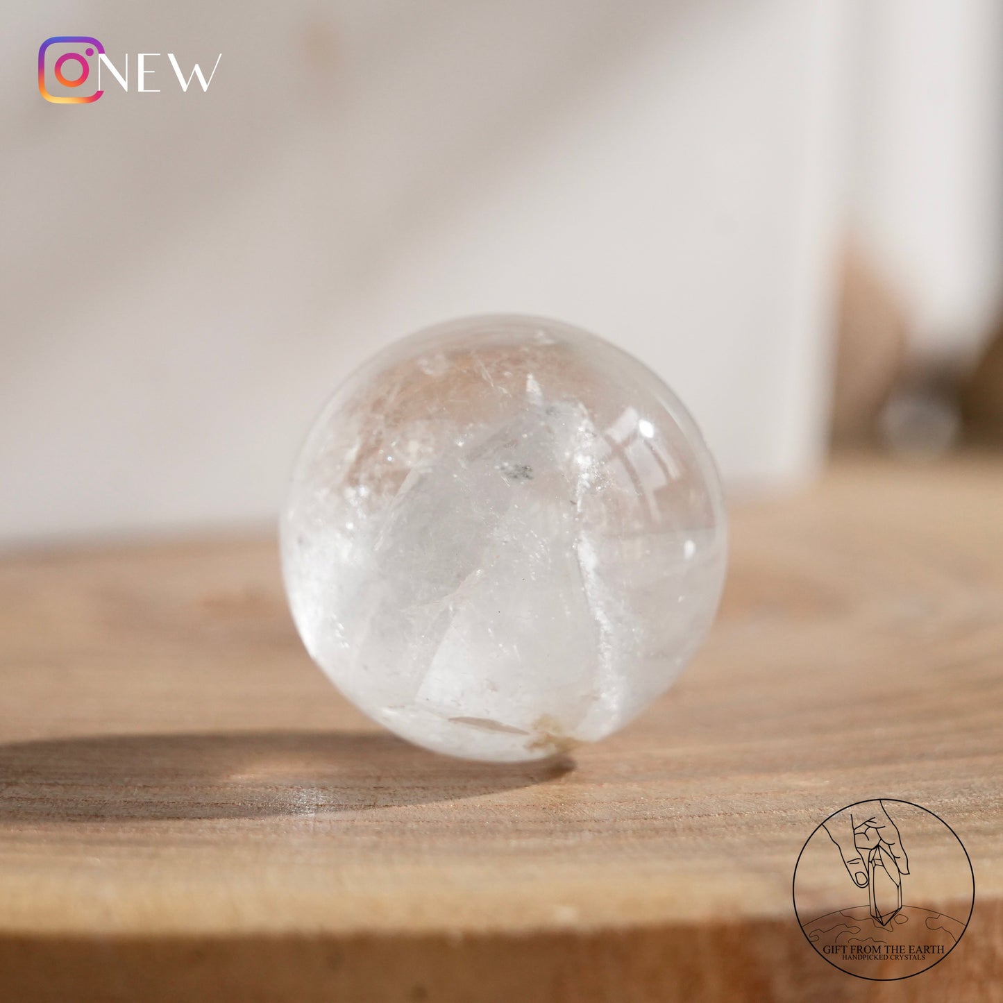 Crystal-in-crystal clear quartz sphere