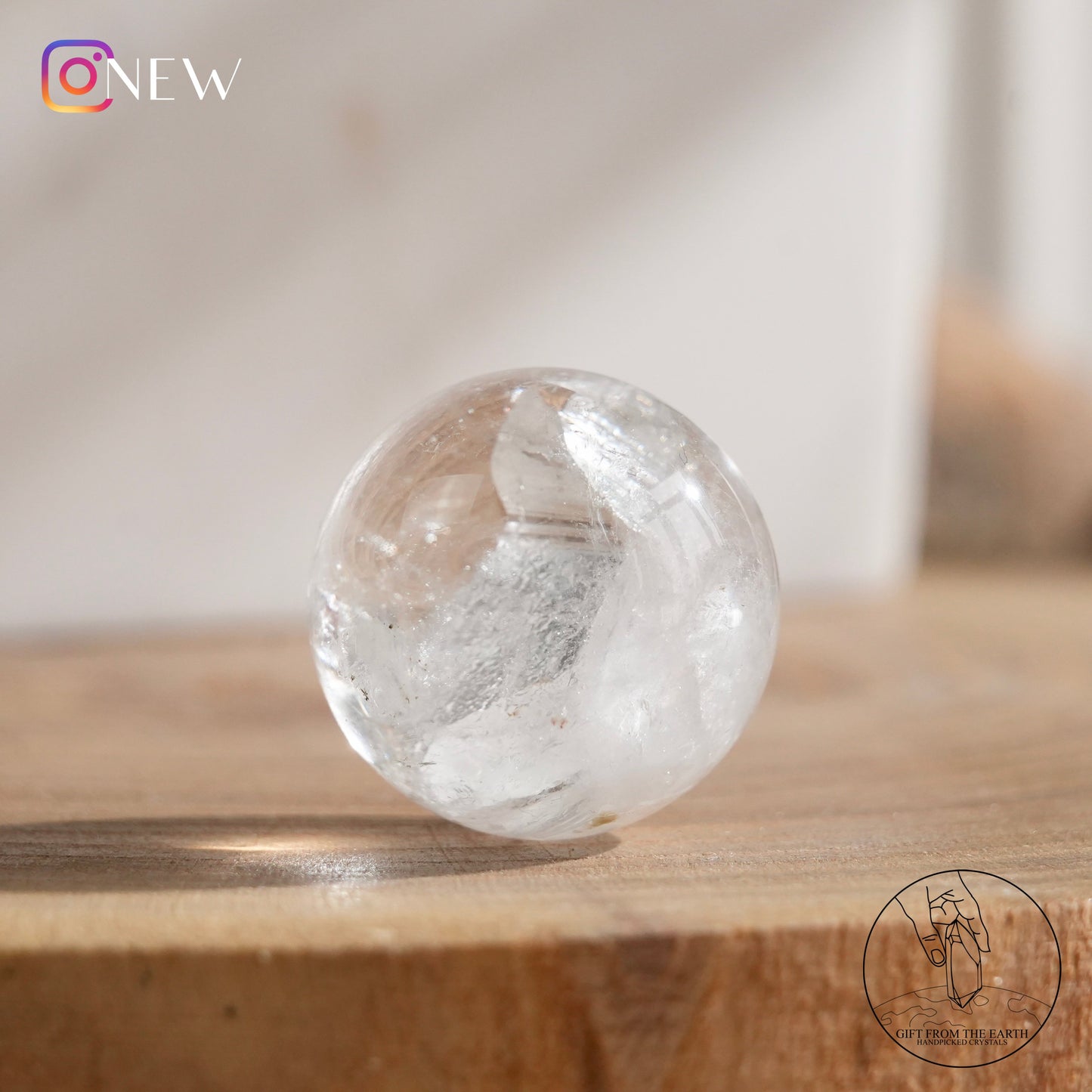 Crystal-in-crystal clear quartz sphere