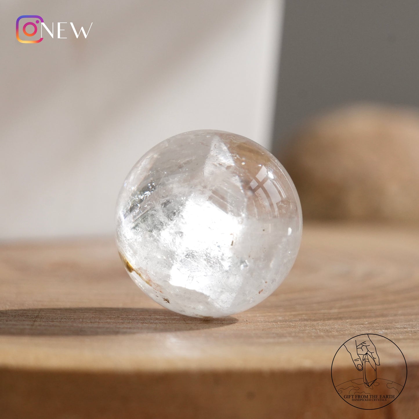 Crystal-in-crystal clear quartz sphere