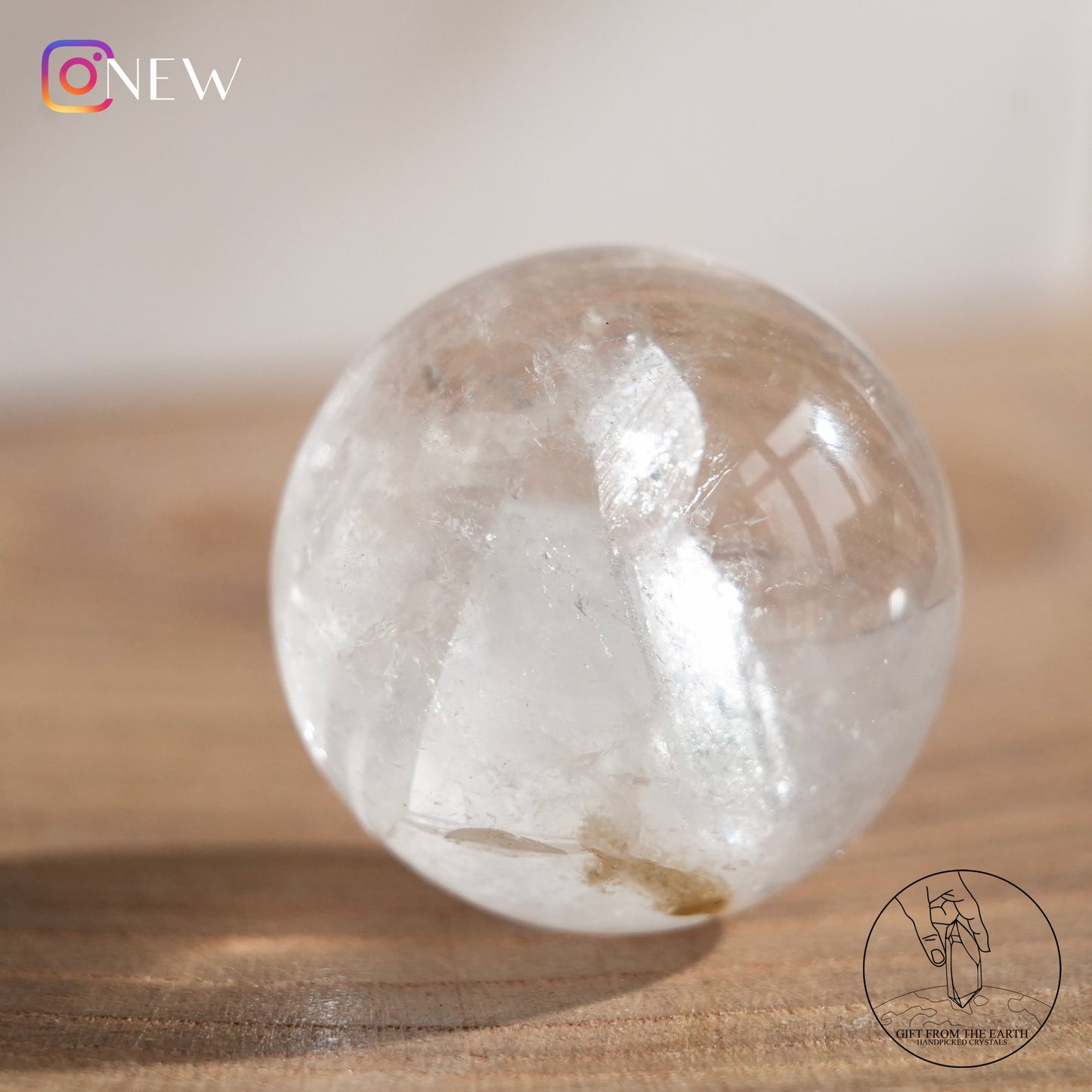 Crystal-in-crystal clear quartz sphere