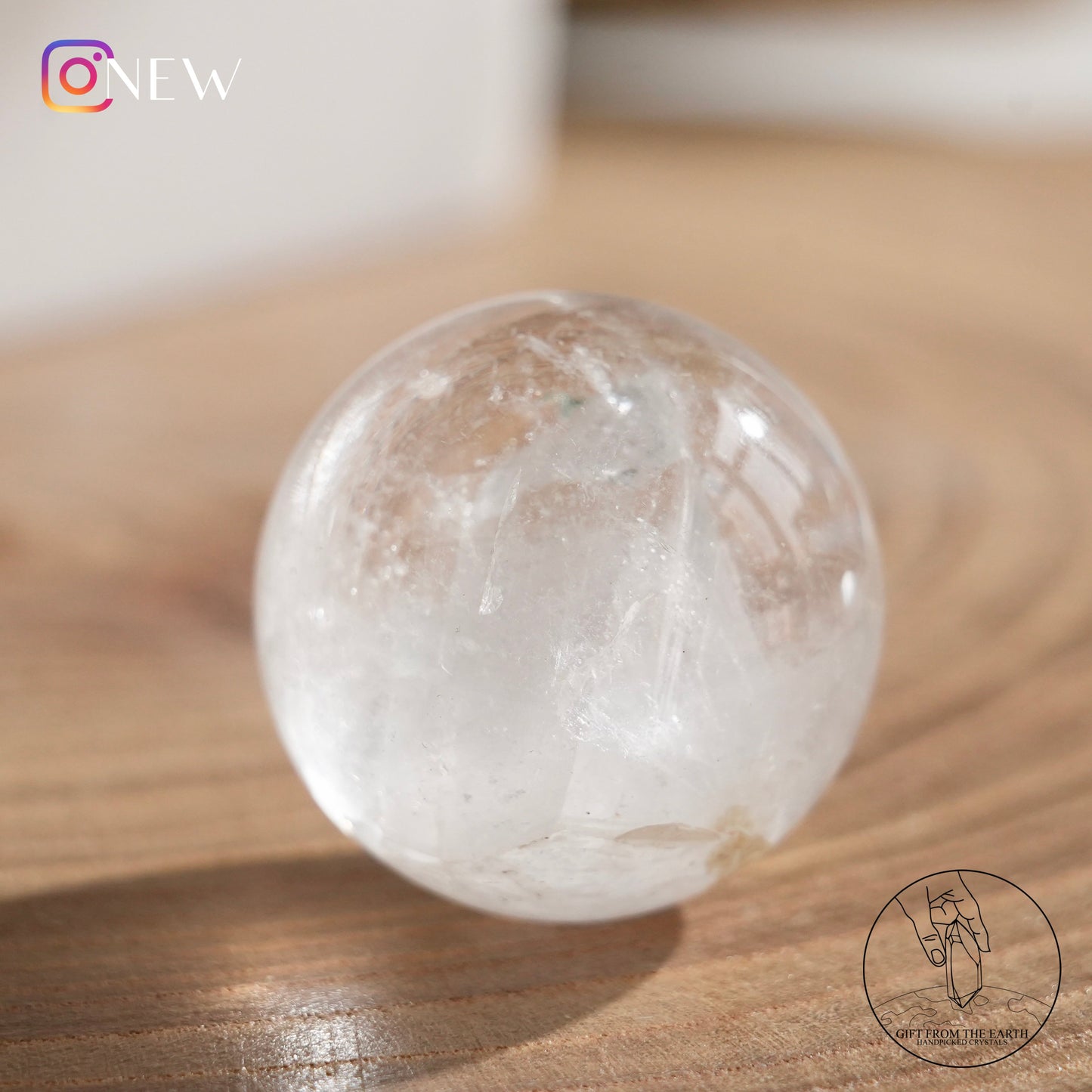 Crystal-in-crystal clear quartz sphere