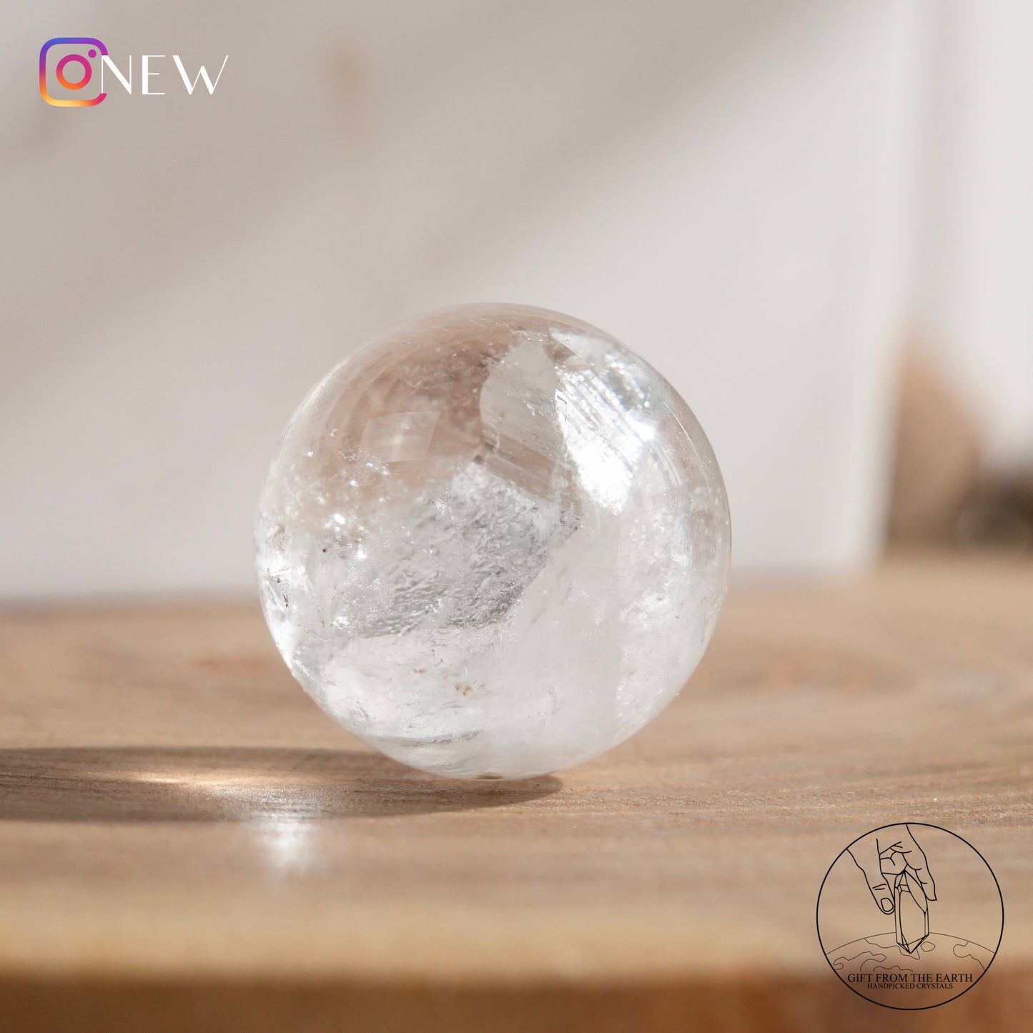 Crystal-in-crystal clear quartz sphere