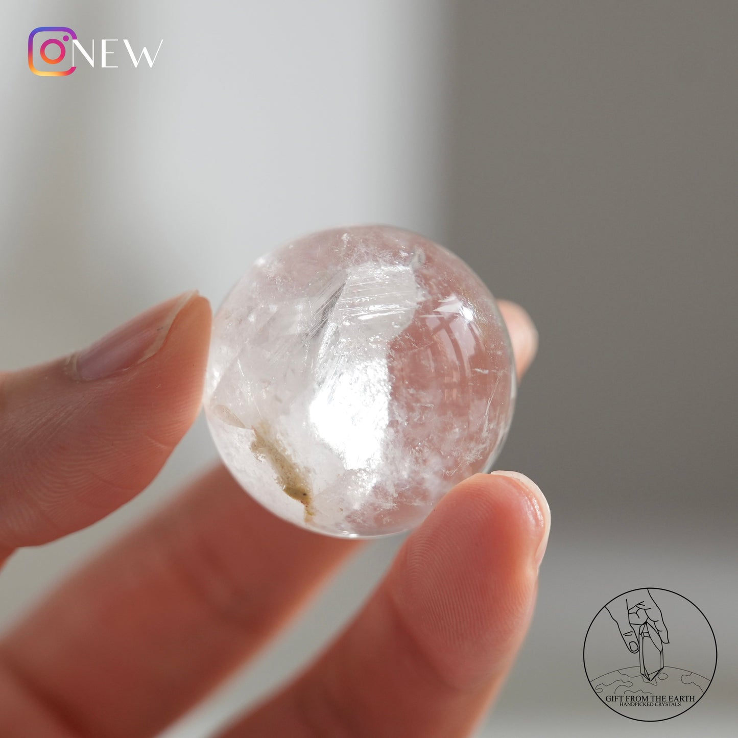 Crystal-in-crystal clear quartz sphere