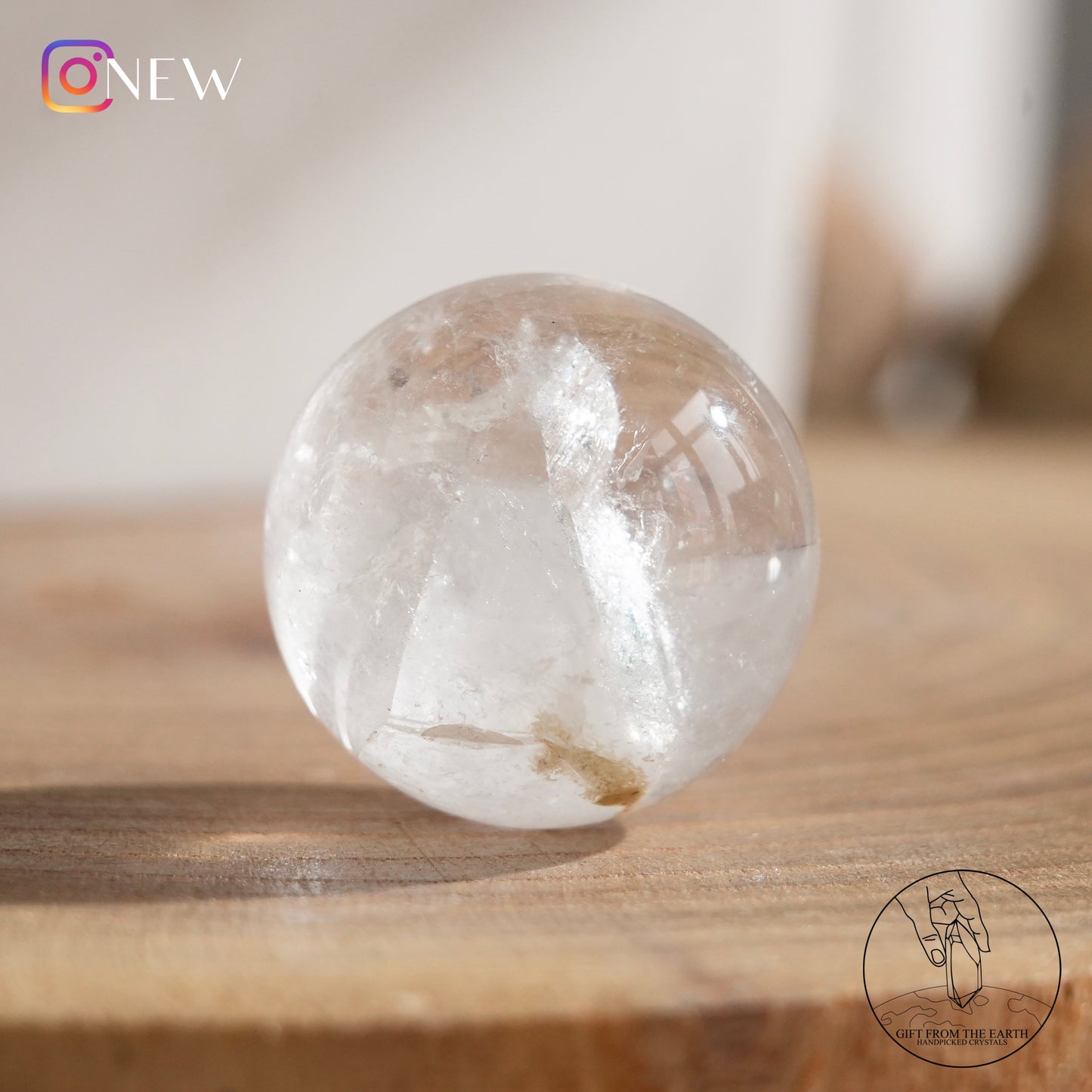 Crystal-in-crystal clear quartz sphere