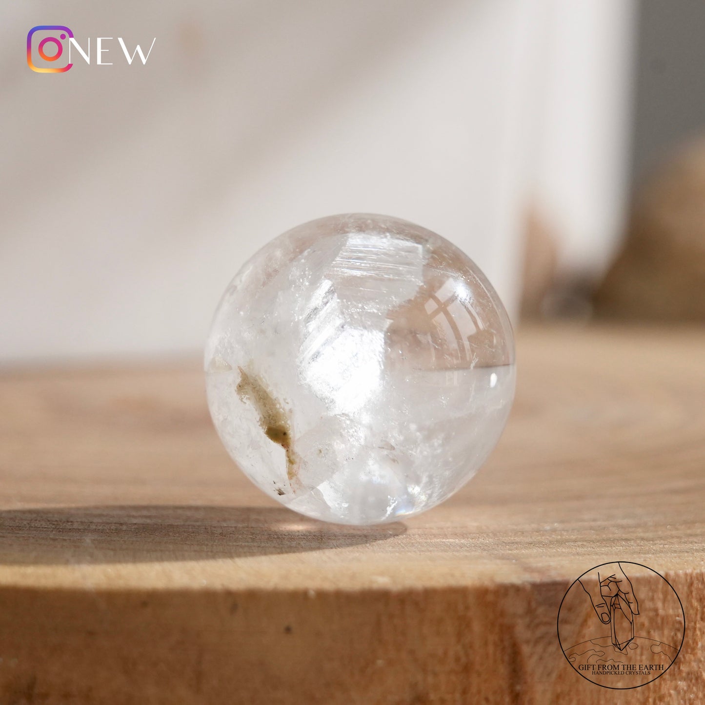 Crystal-in-crystal clear quartz sphere