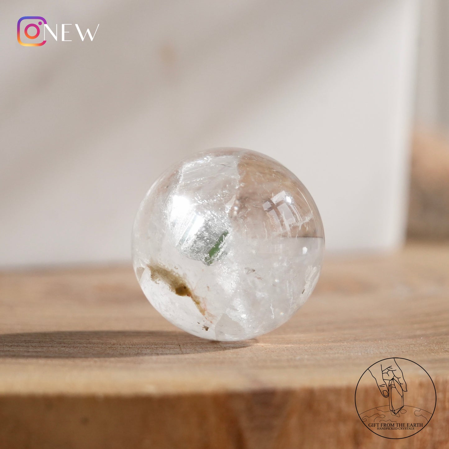 Crystal-in-crystal clear quartz sphere