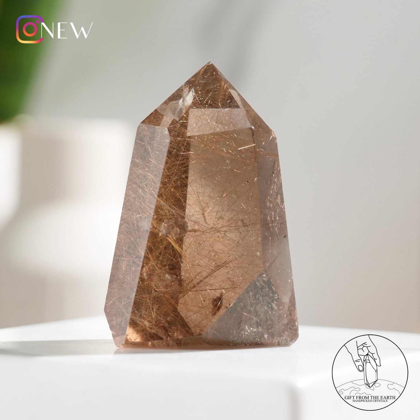 Crystal-in-crystal golden rutilated quartz point with white phantom