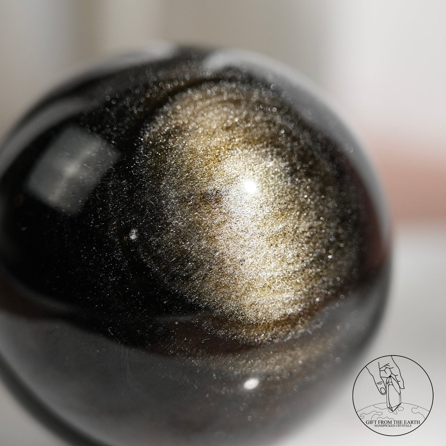 Golden sheen obsidian sphere