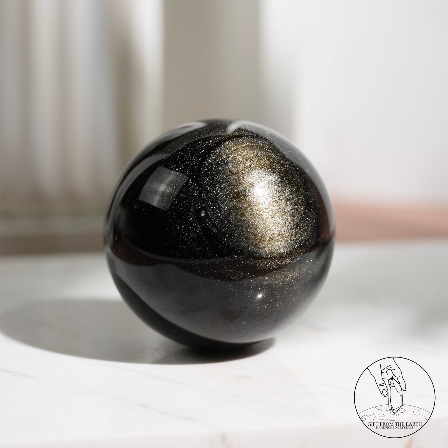 Golden sheen obsidian sphere