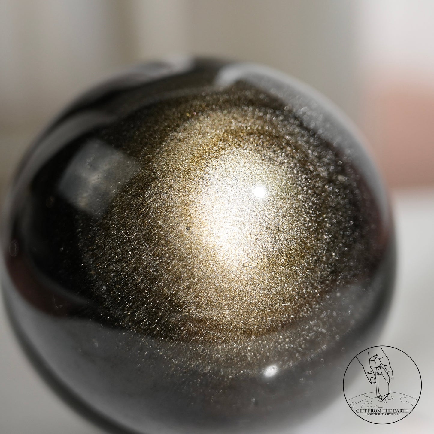 Golden sheen obsidian sphere