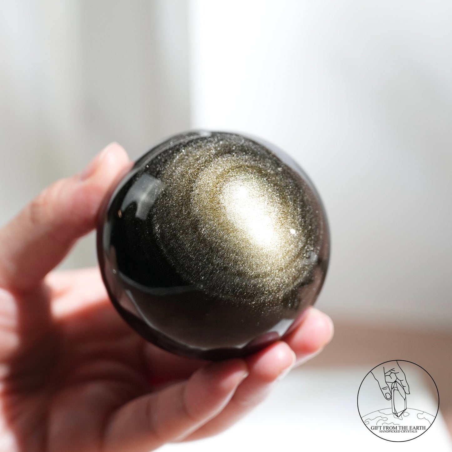 Golden sheen obsidian sphere