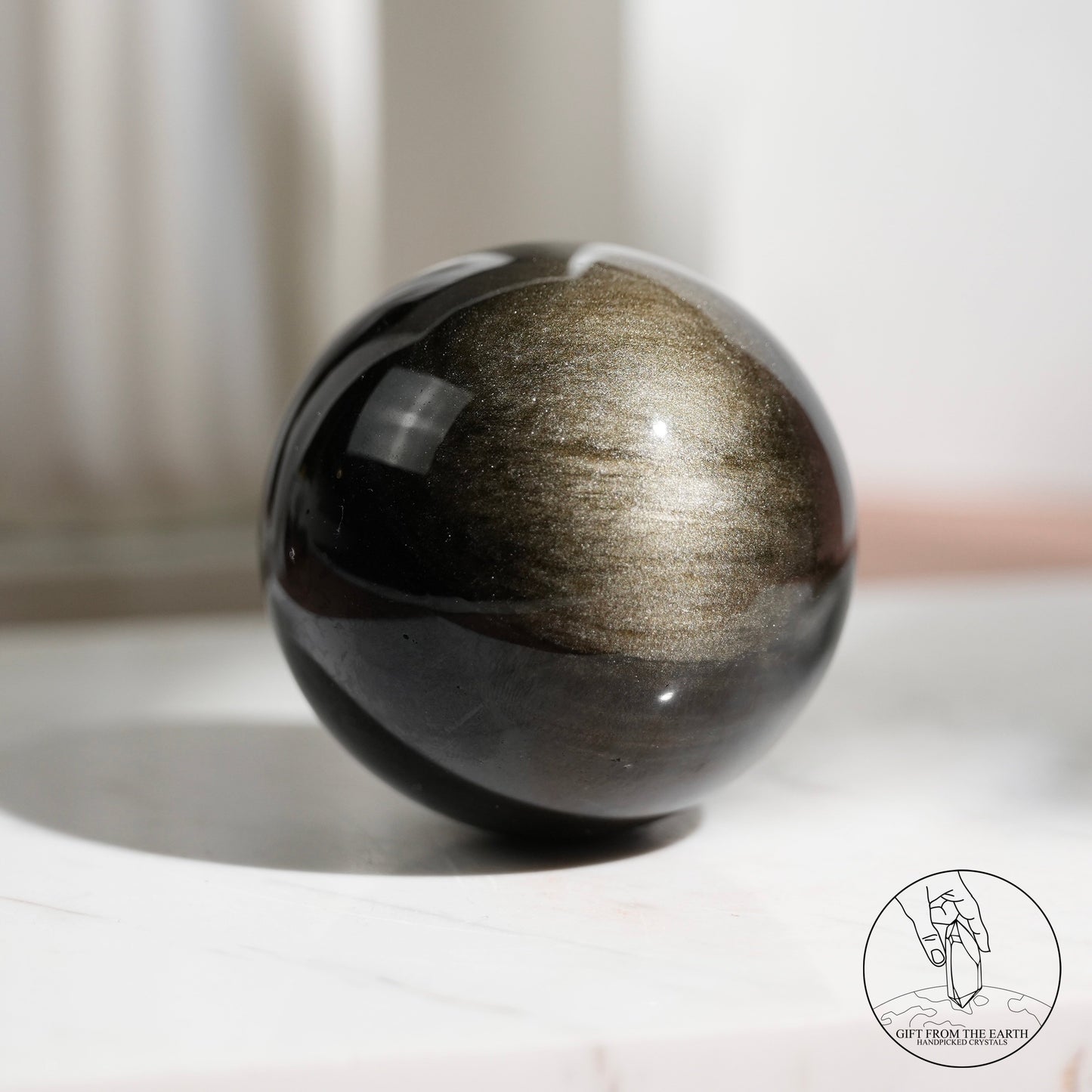 Golden sheen obsidian sphere