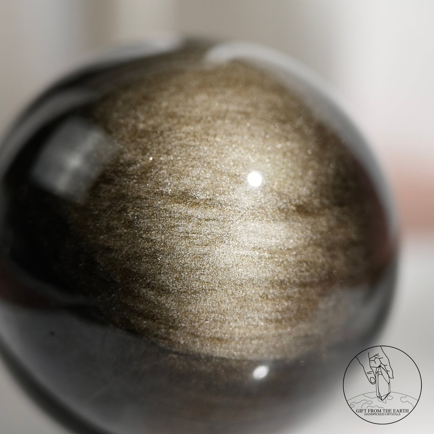 Golden sheen obsidian sphere