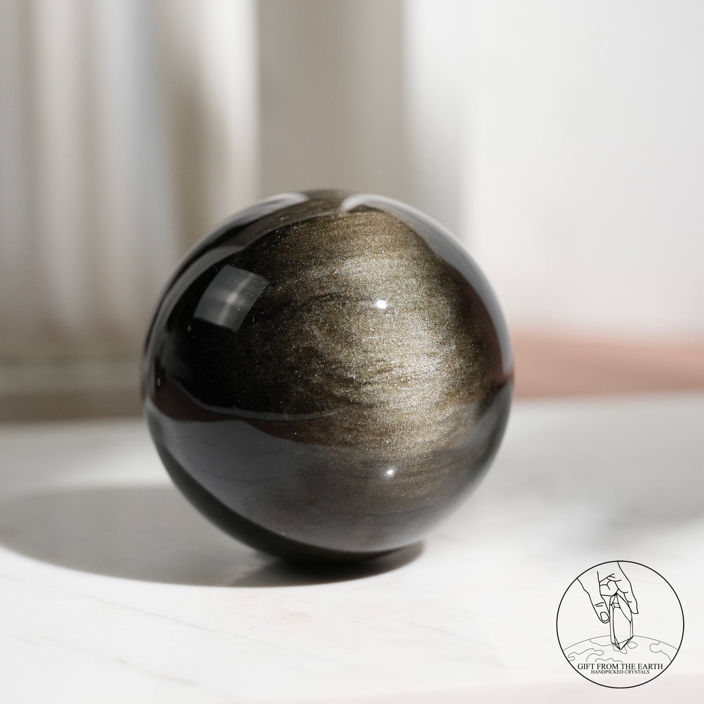 Golden sheen obsidian sphere