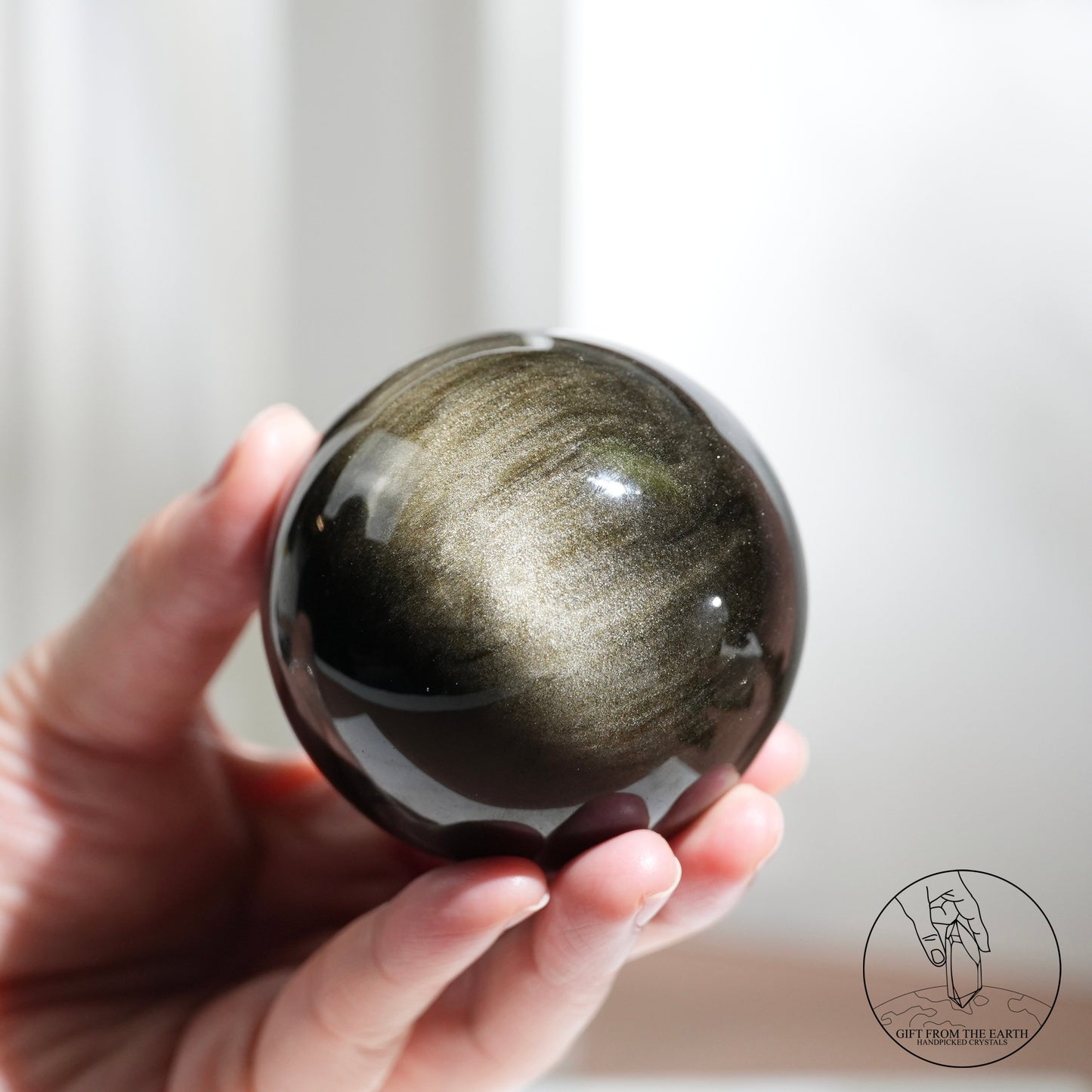 Golden sheen obsidian sphere