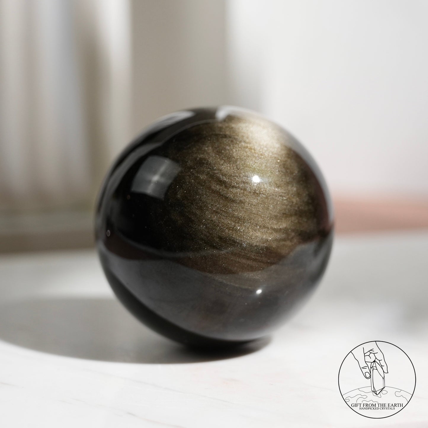 Golden sheen obsidian sphere