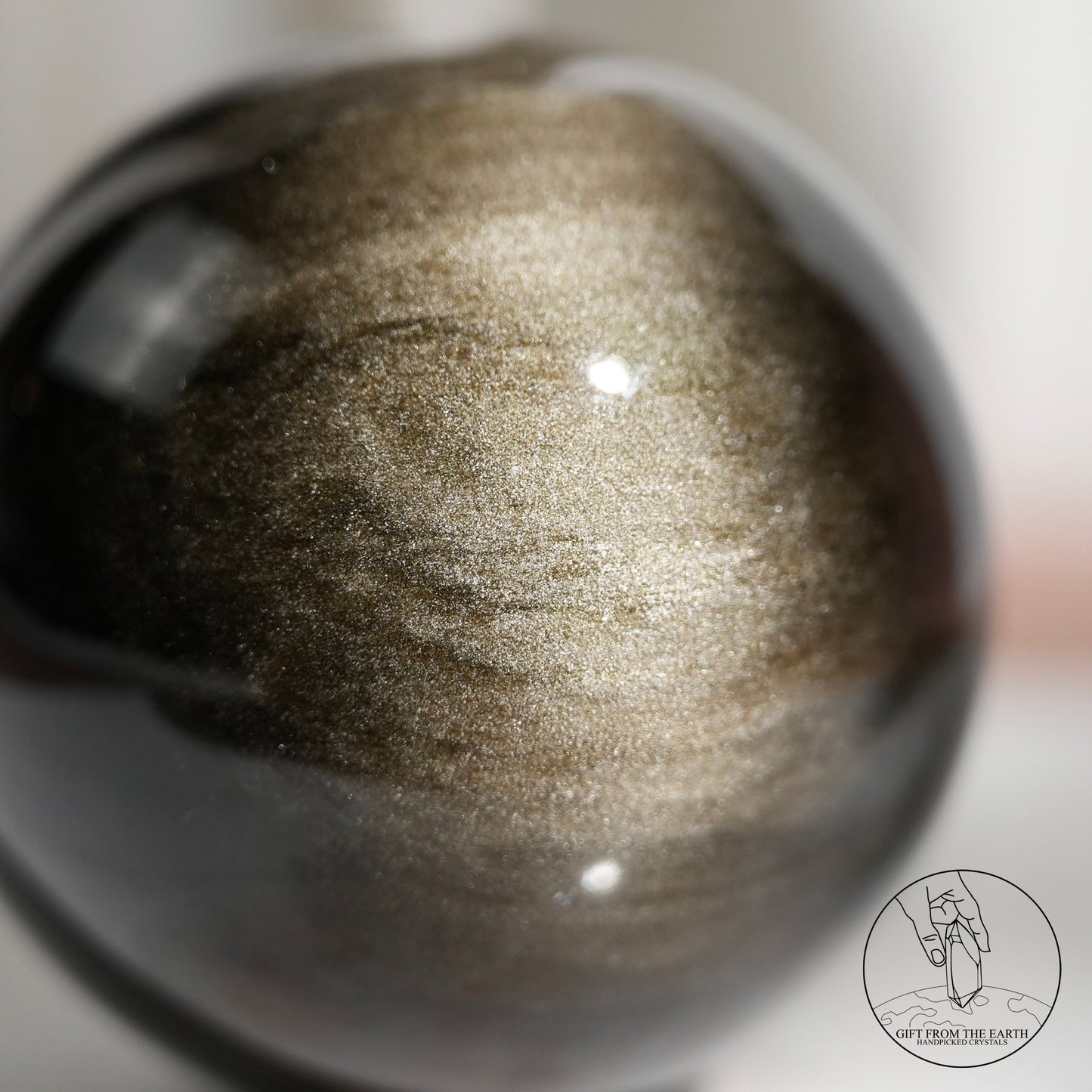 Golden sheen obsidian sphere