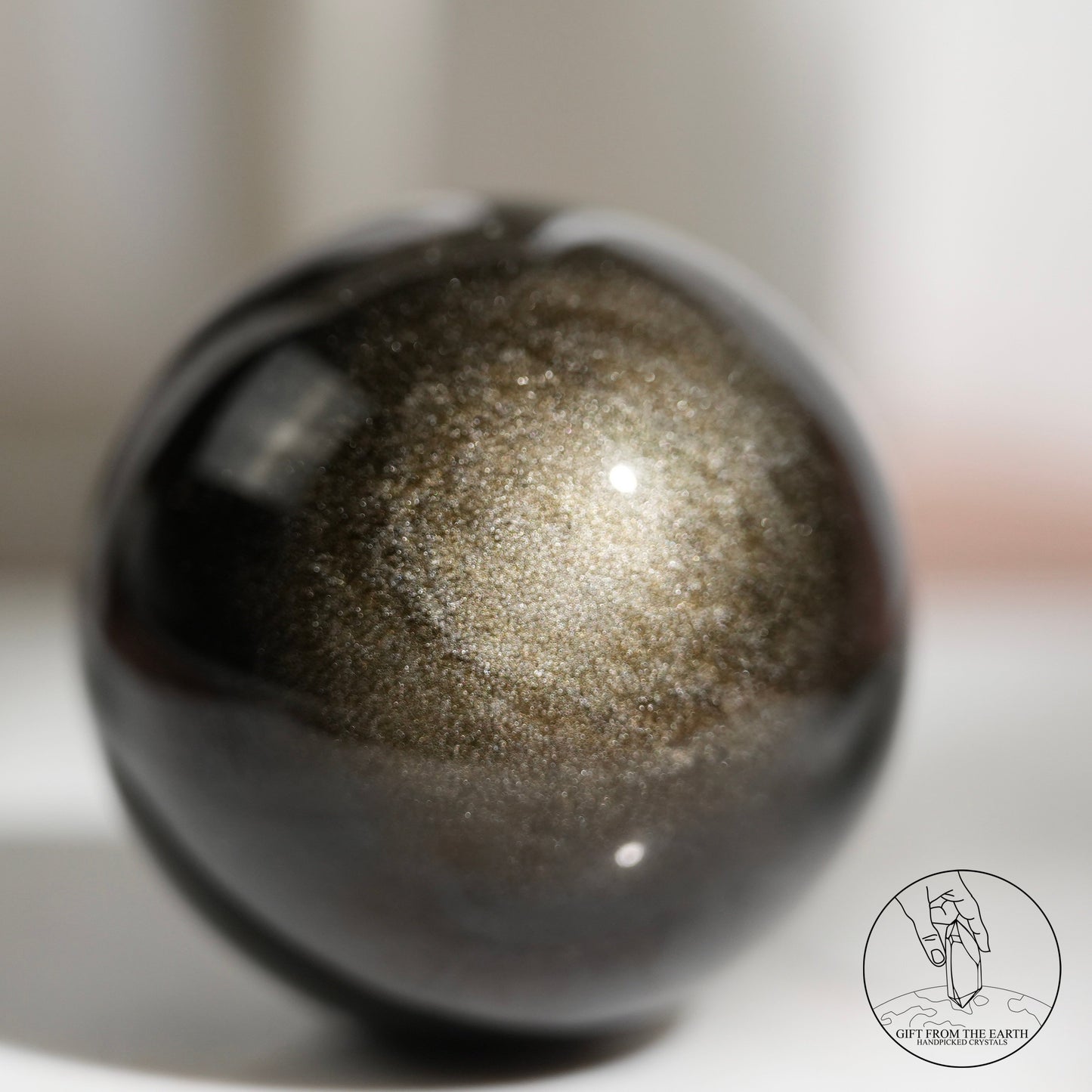 Golden sheen obsidian sphere