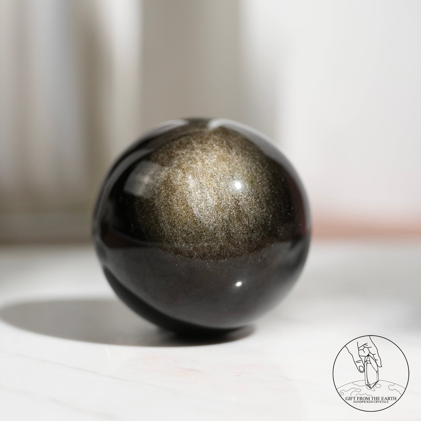 Golden sheen obsidian sphere