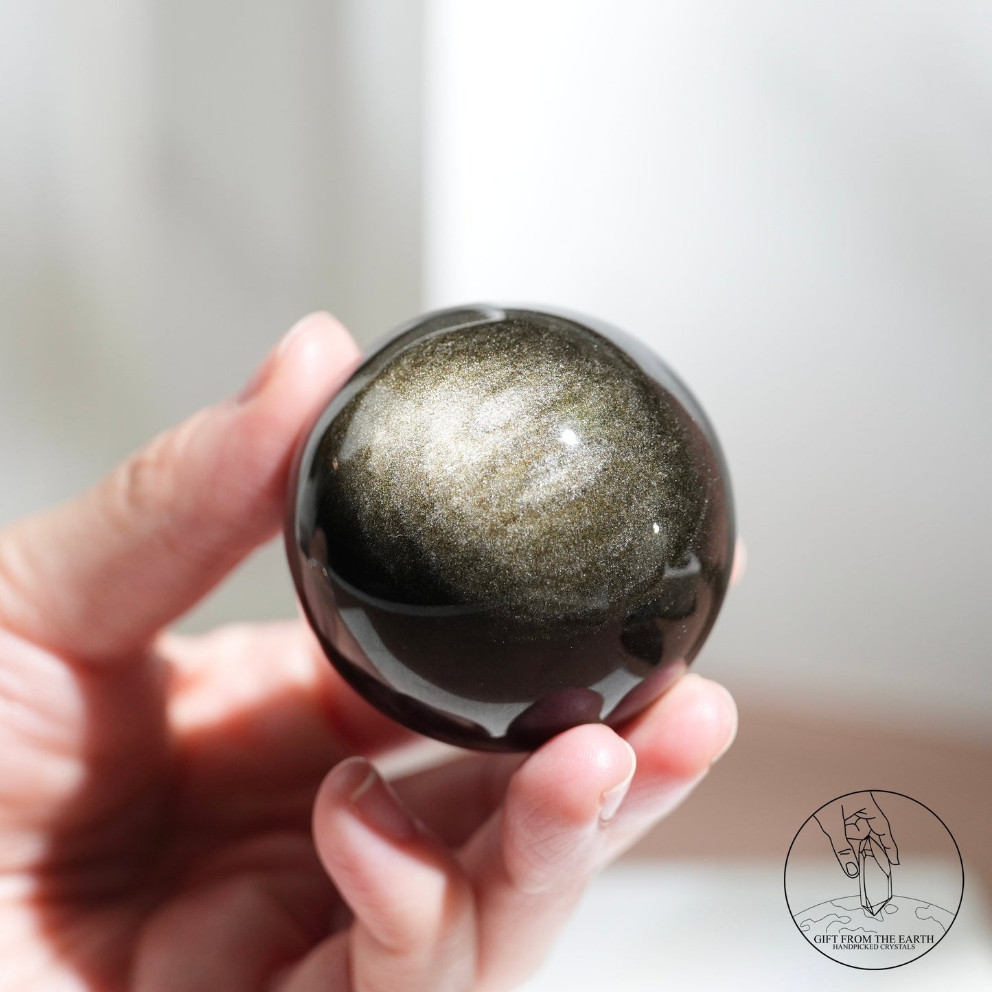 Golden sheen obsidian sphere