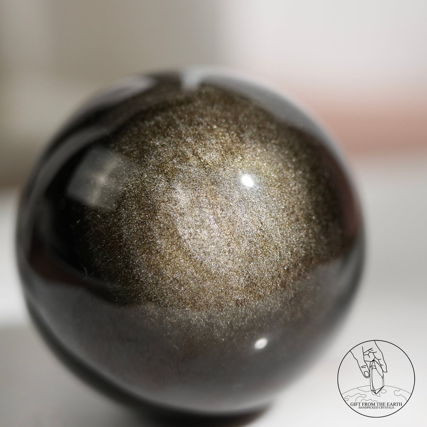 Golden sheen obsidian sphere