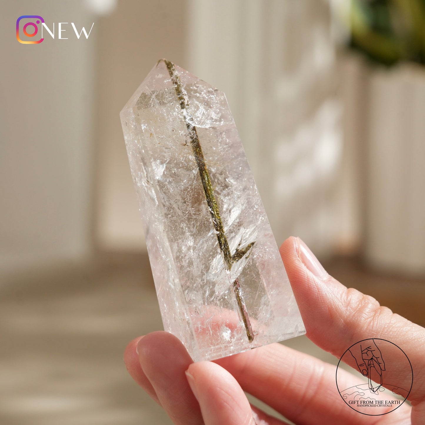 Green tourmaline in clear quartz point