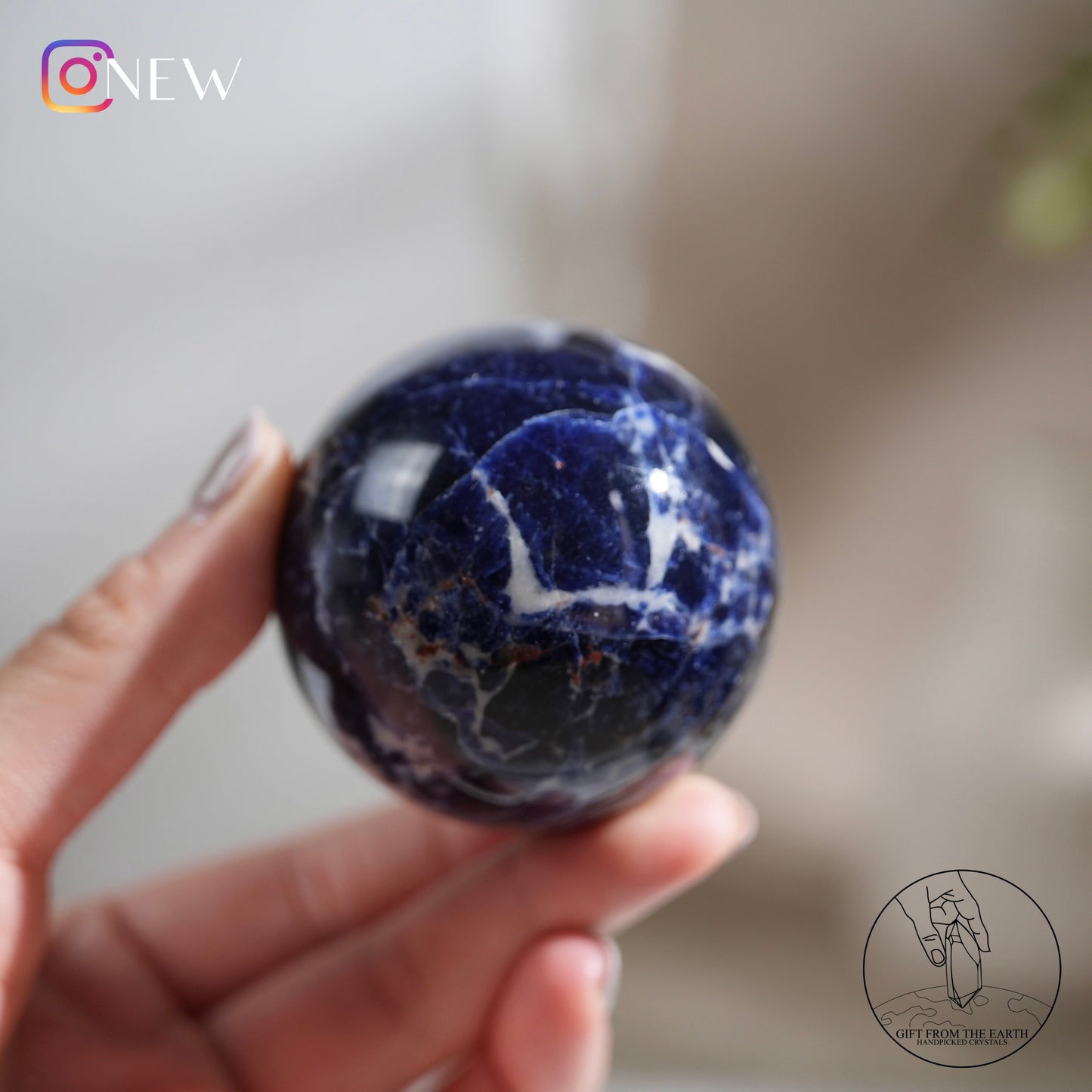 Larimar sphere with feldspar