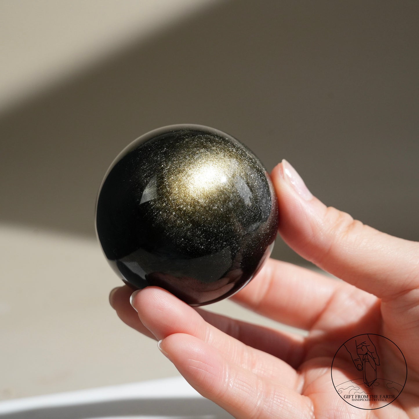 Golden obsidian sphere