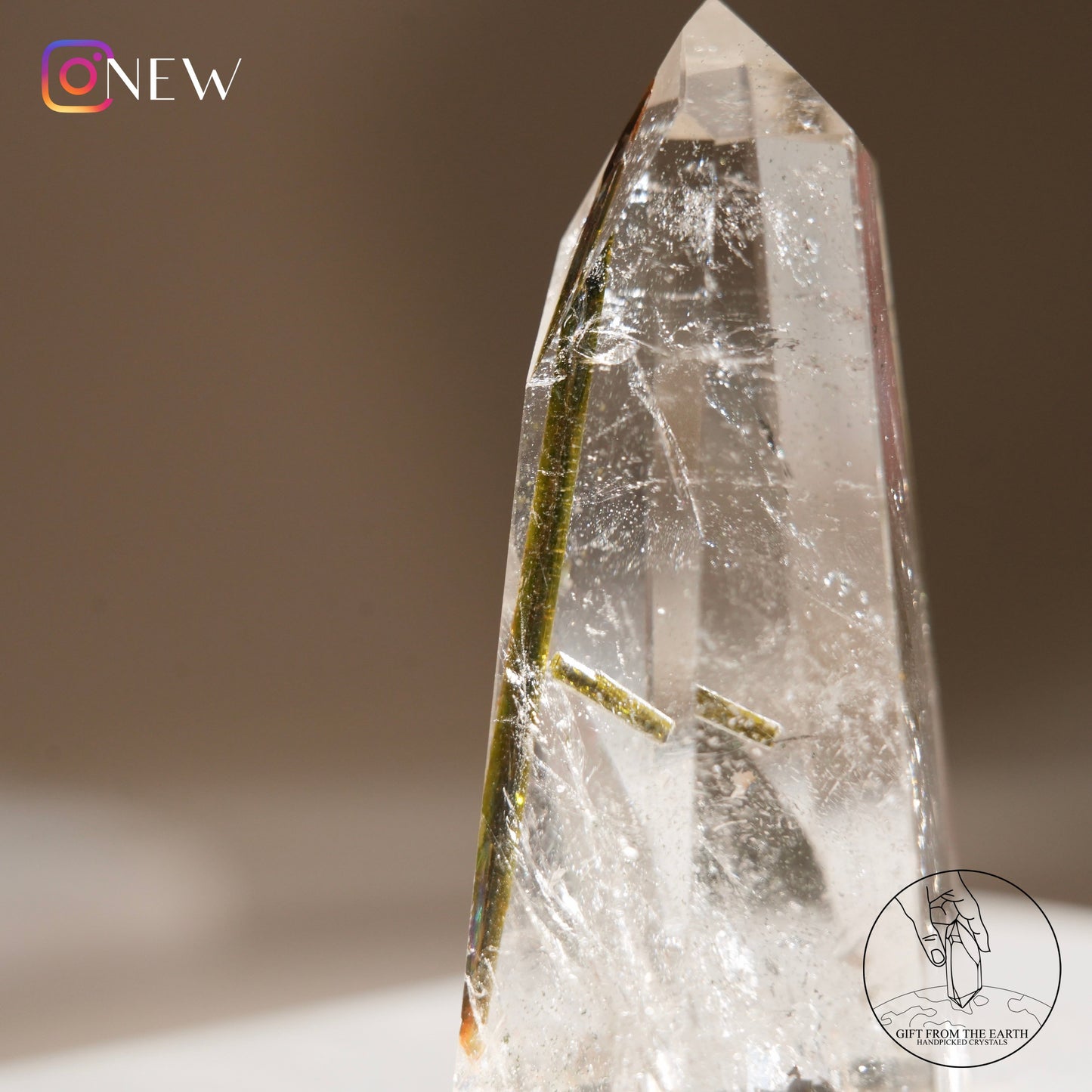 Green tourmaline in clear quartz point