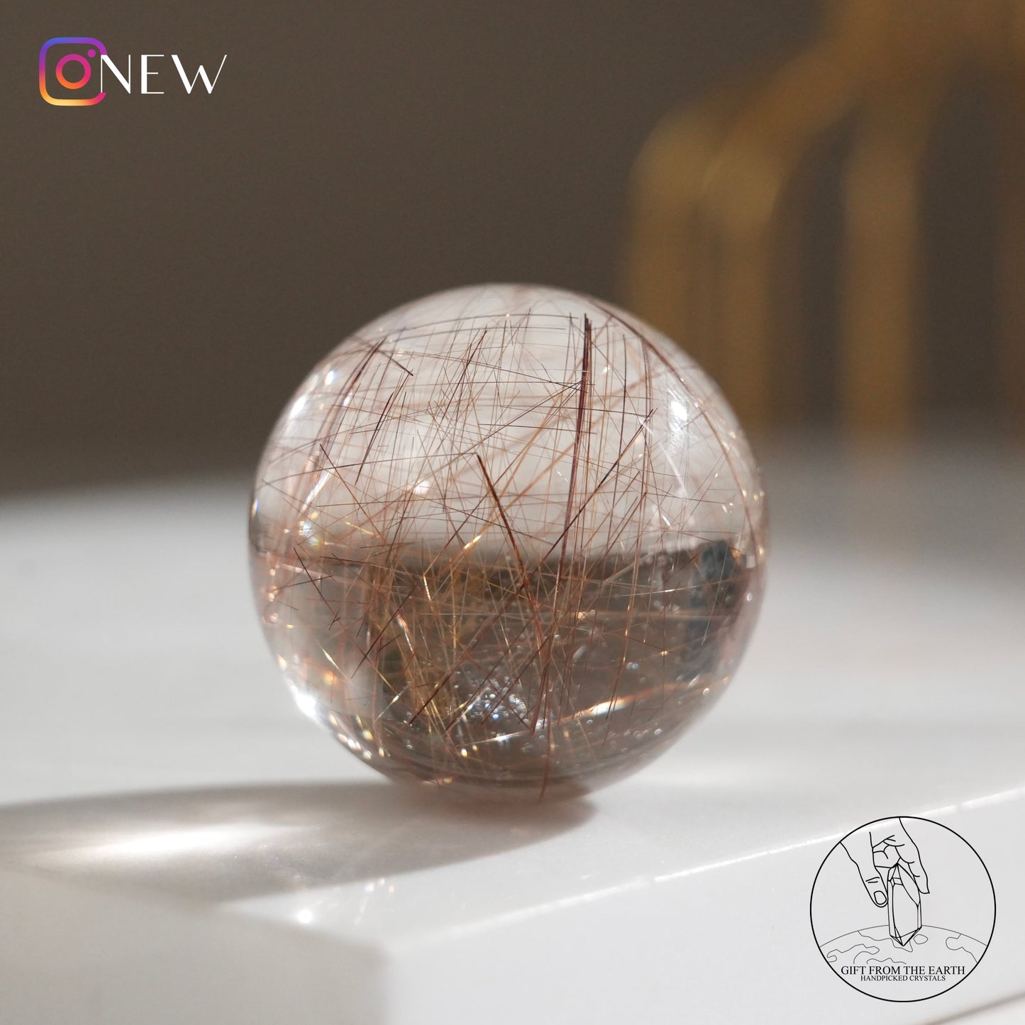 Golden rutilated quartz sphere