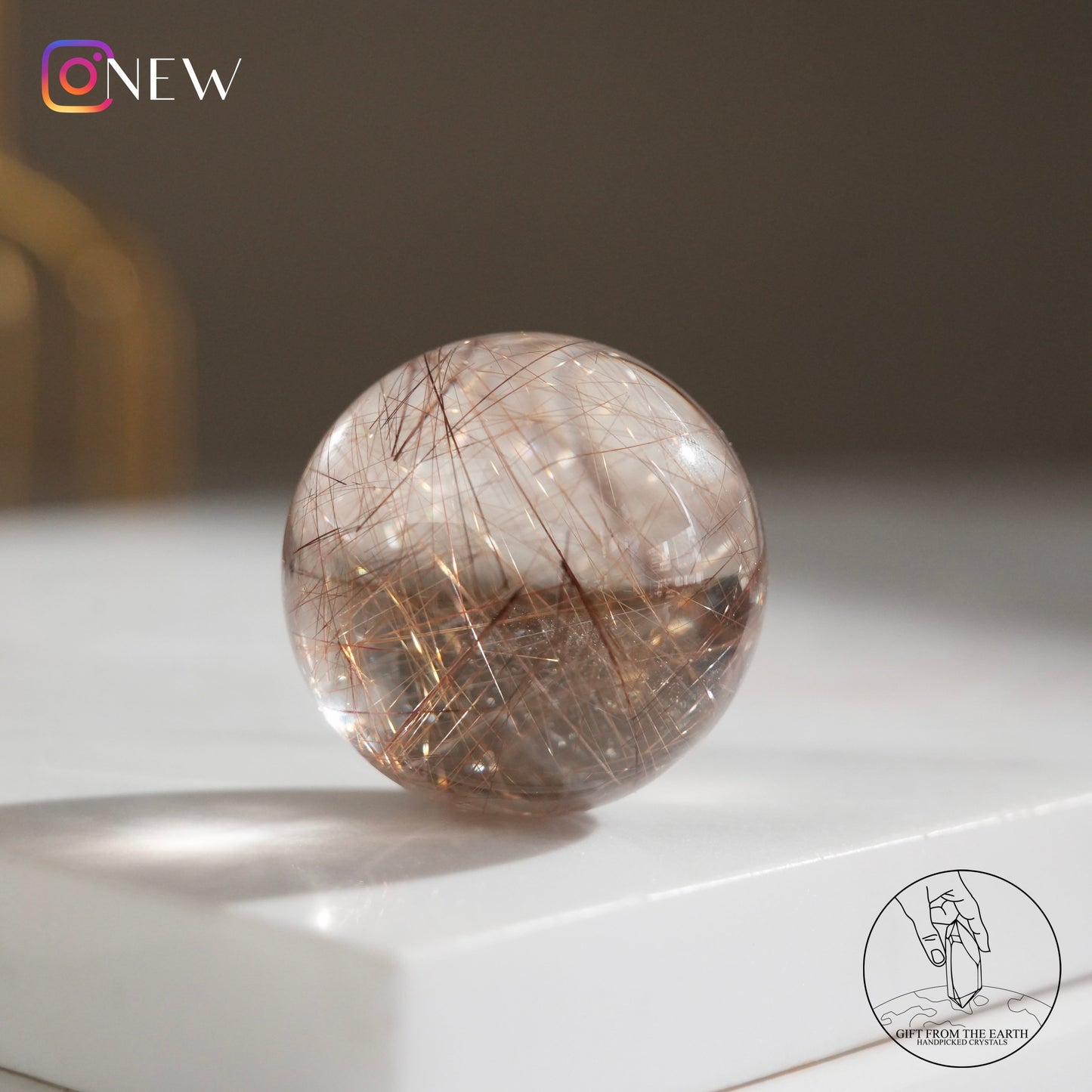 Golden rutilated quartz sphere