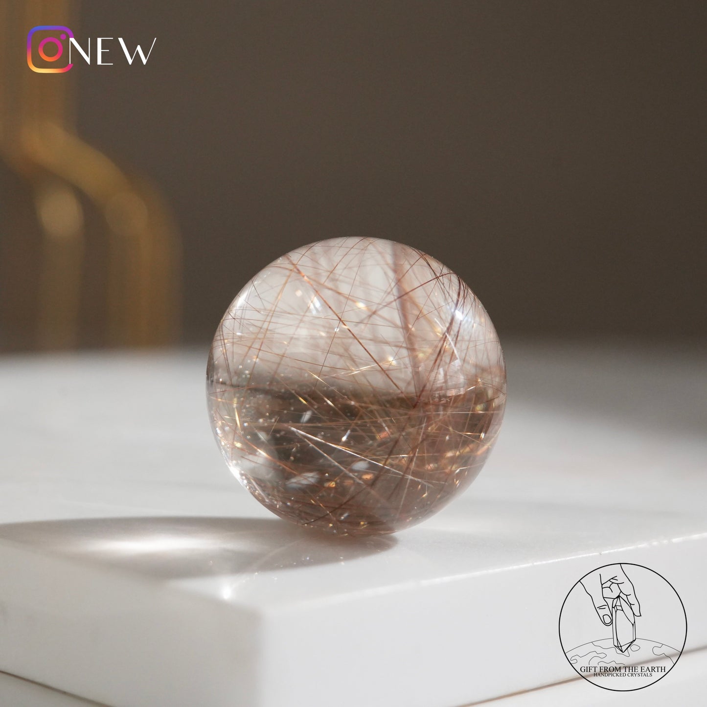 Golden rutilated quartz sphere