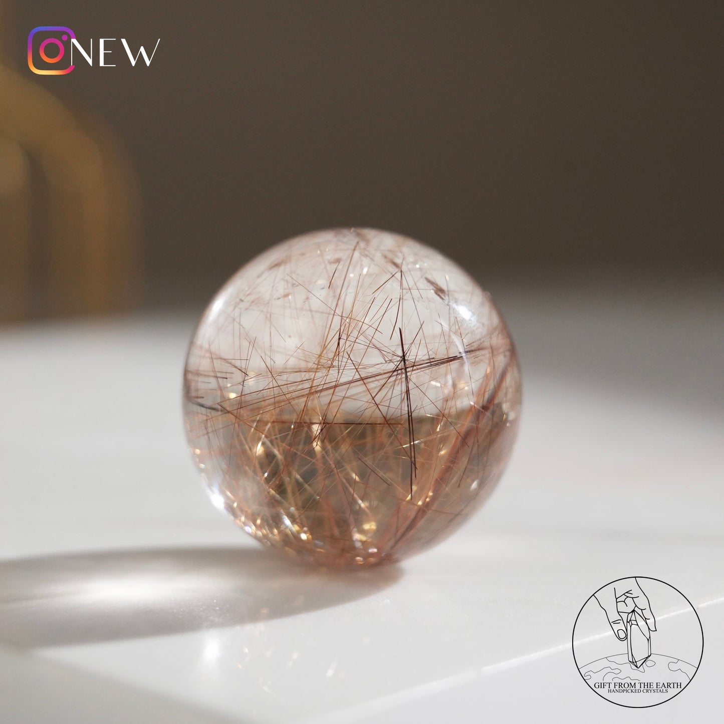 Golden rutilated quartz sphere