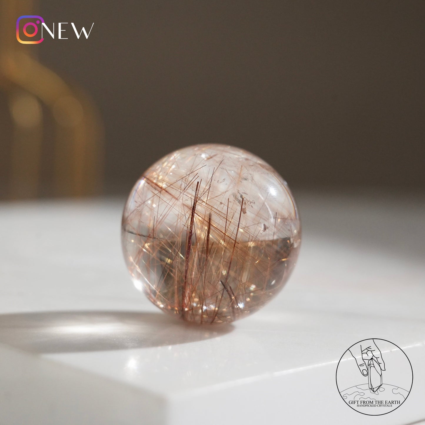 Golden rutilated quartz sphere