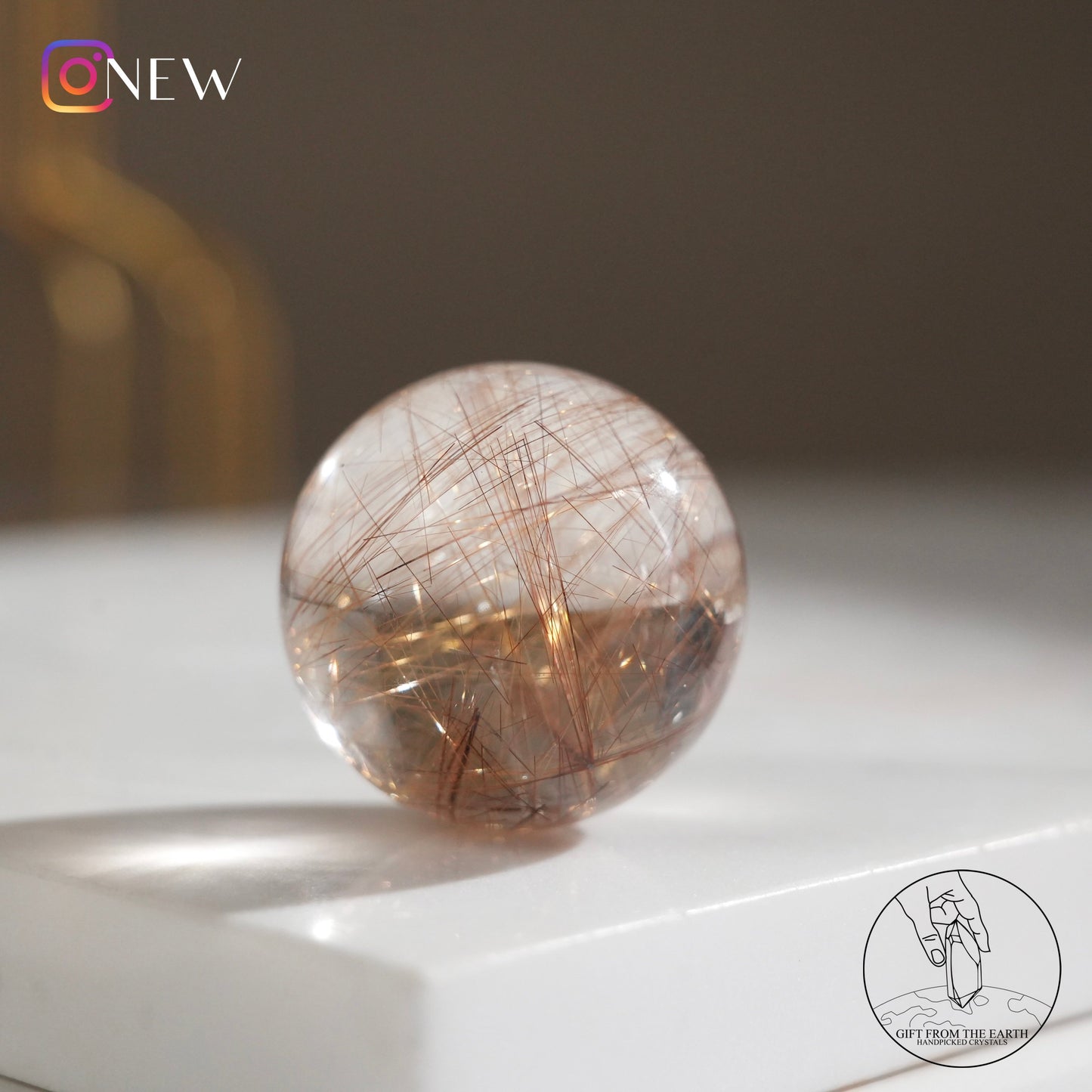 Golden rutilated quartz sphere