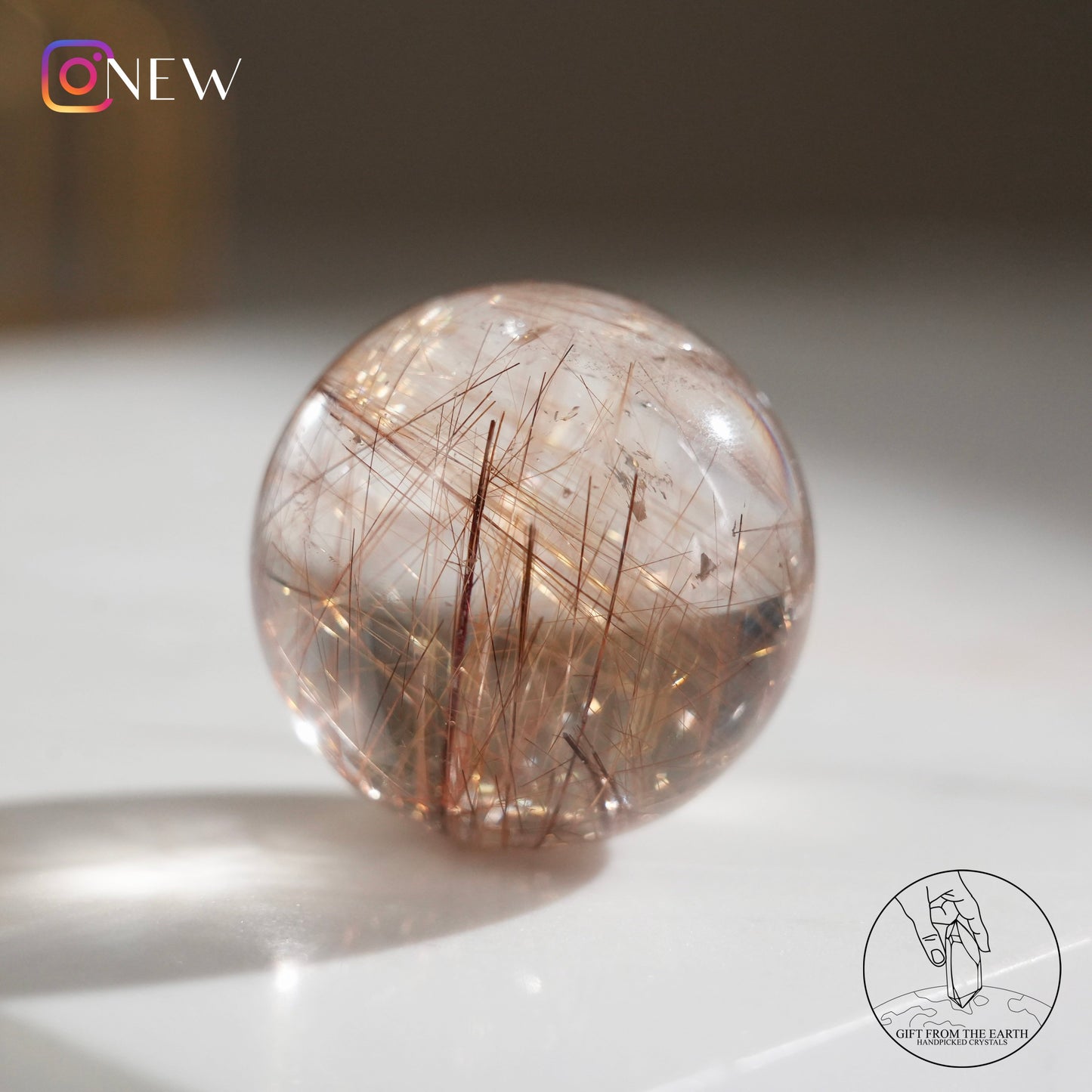 Golden rutilated quartz sphere