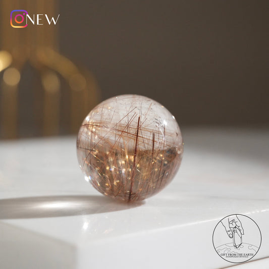 Golden rutilated quartz sphere