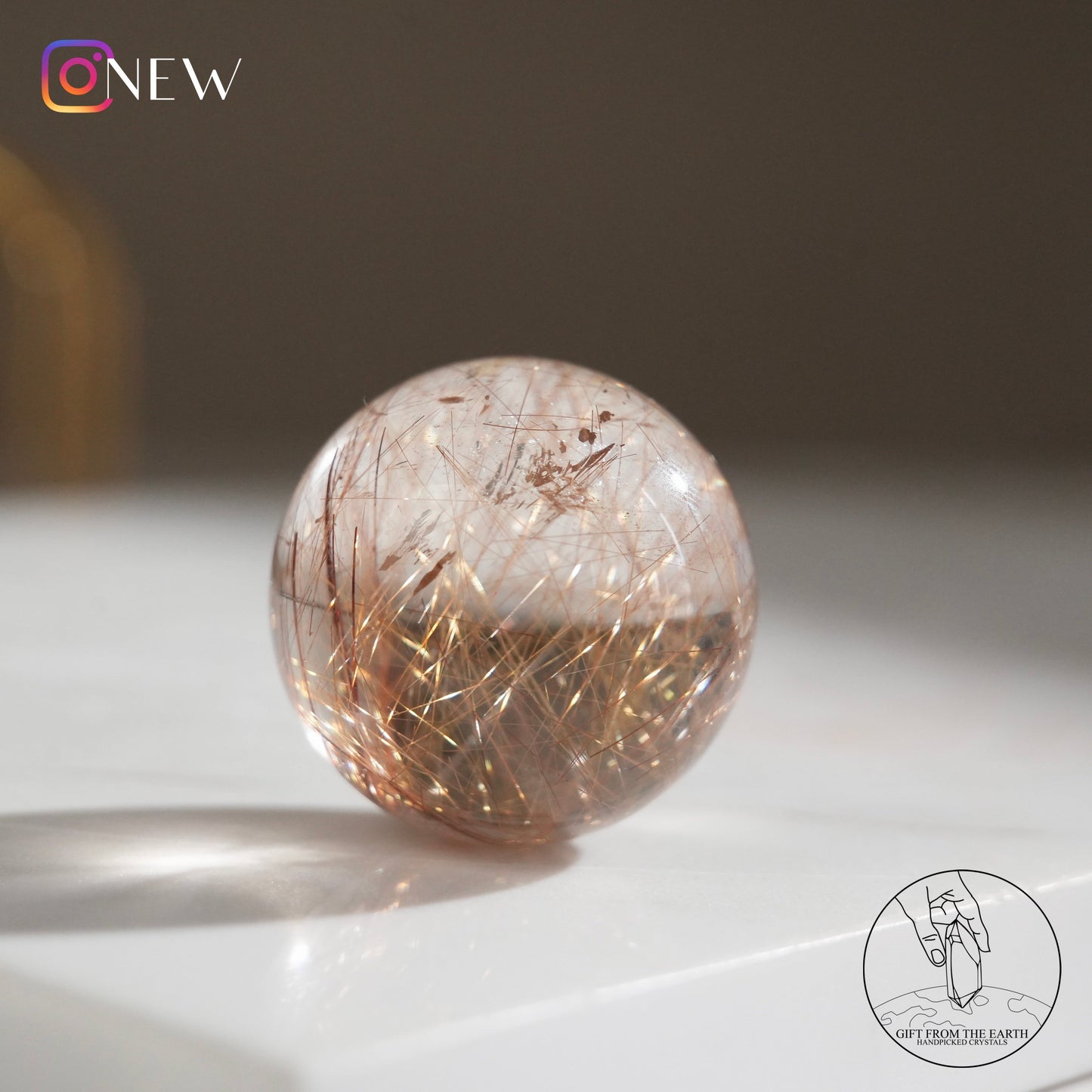 Golden rutilated quartz sphere