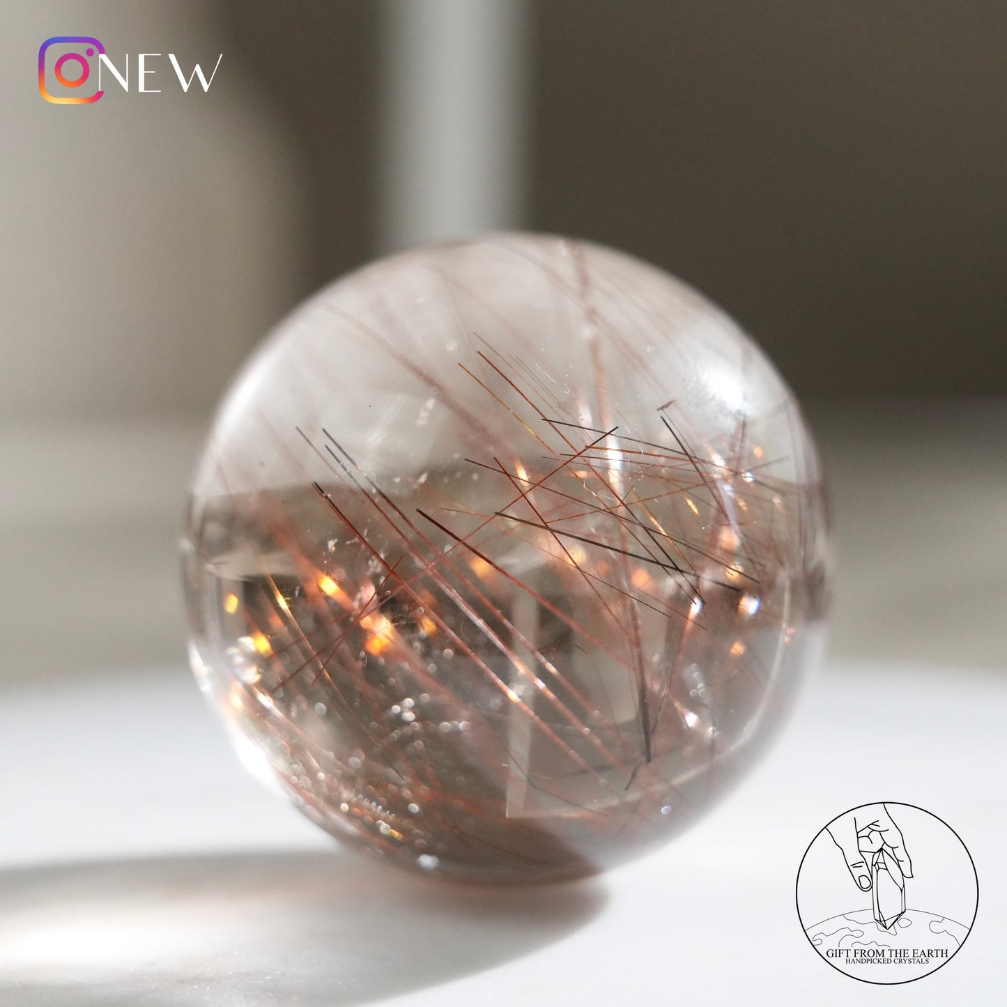 Red rutilated quartz sphere