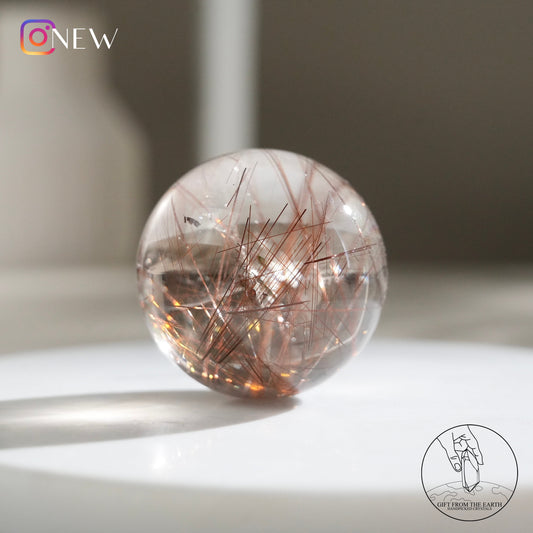 Red rutilated quartz sphere