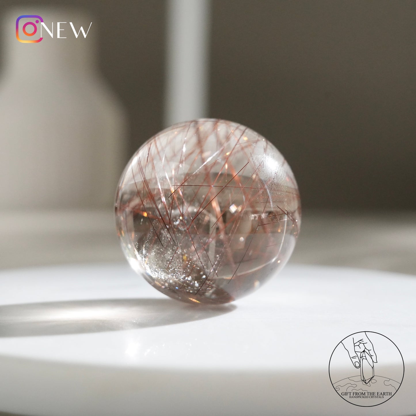 Red rutilated quartz sphere