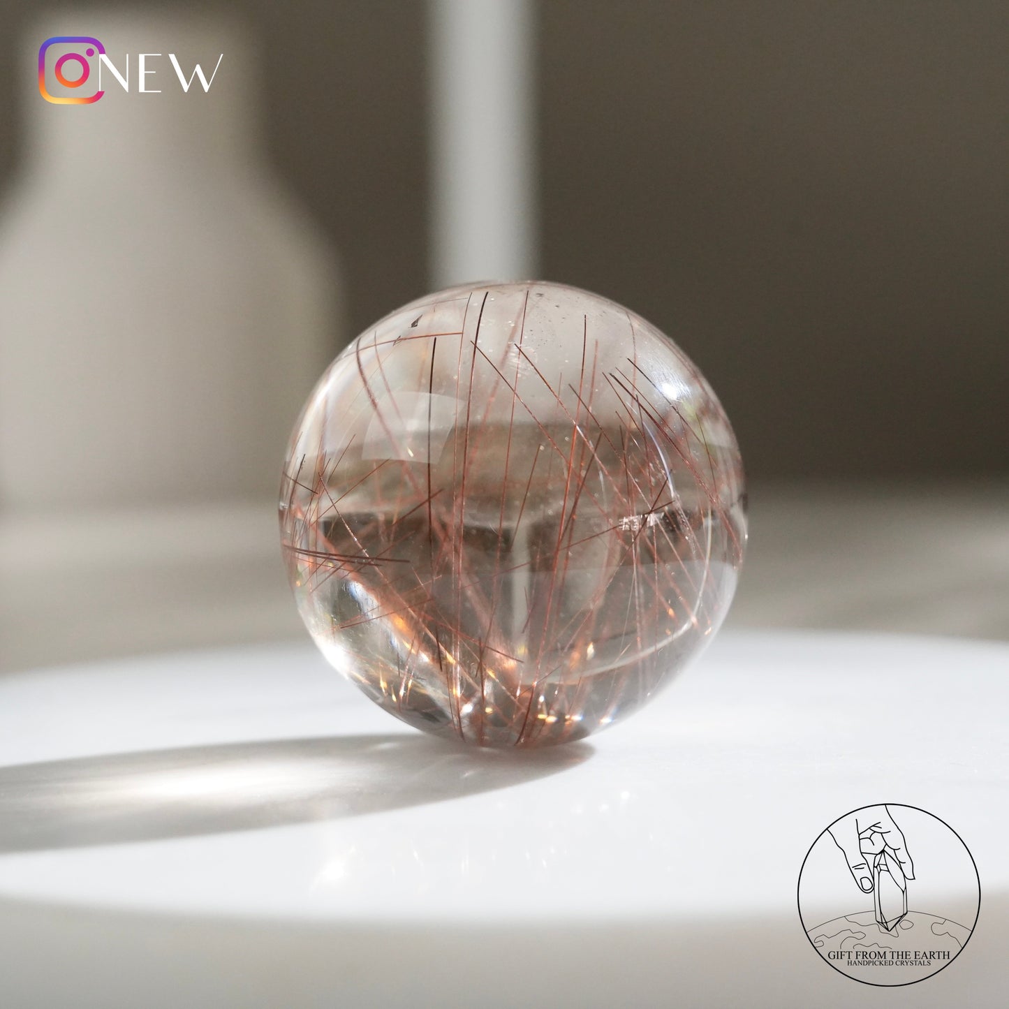 Red rutilated quartz sphere