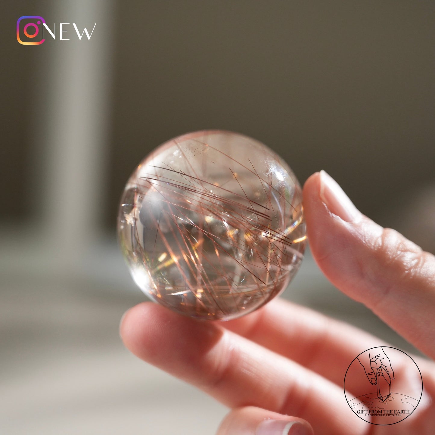 Red rutilated quartz sphere