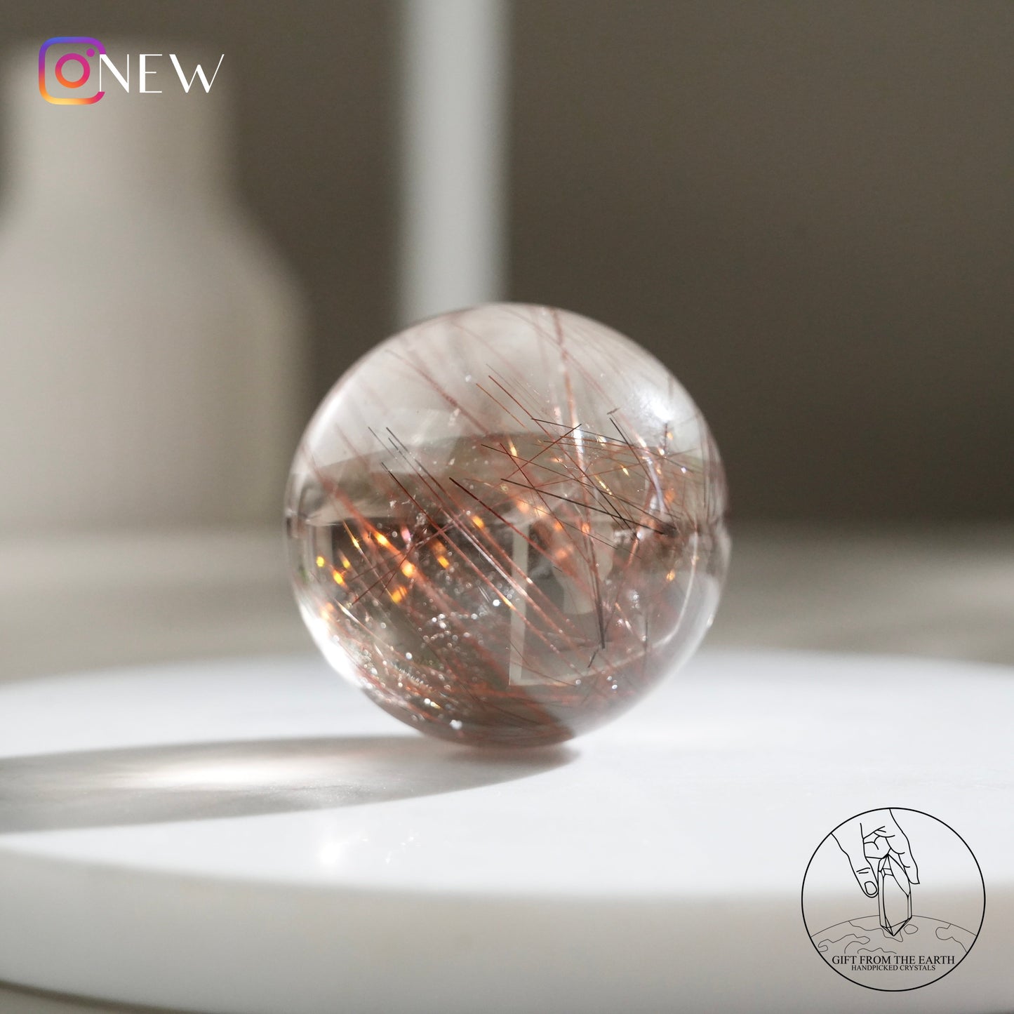 Red rutilated quartz sphere