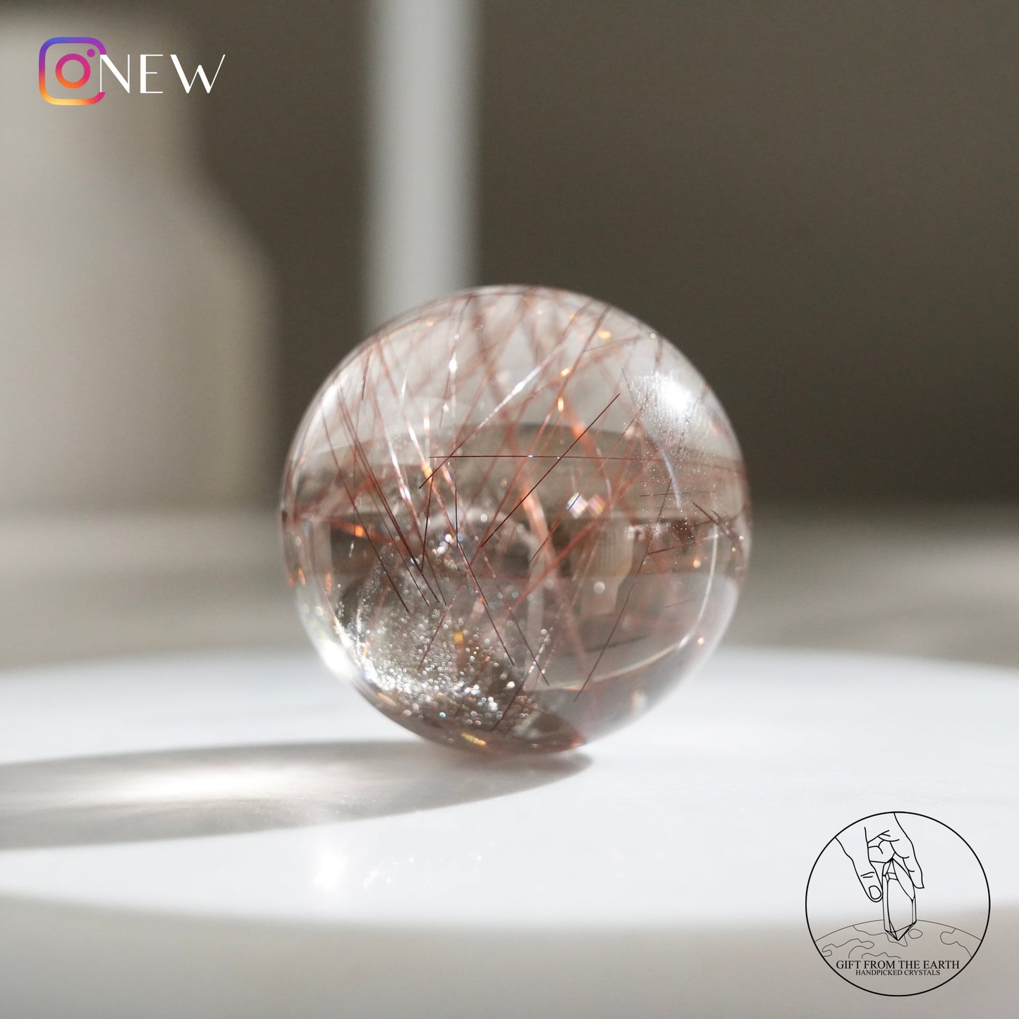 Red rutilated quartz sphere