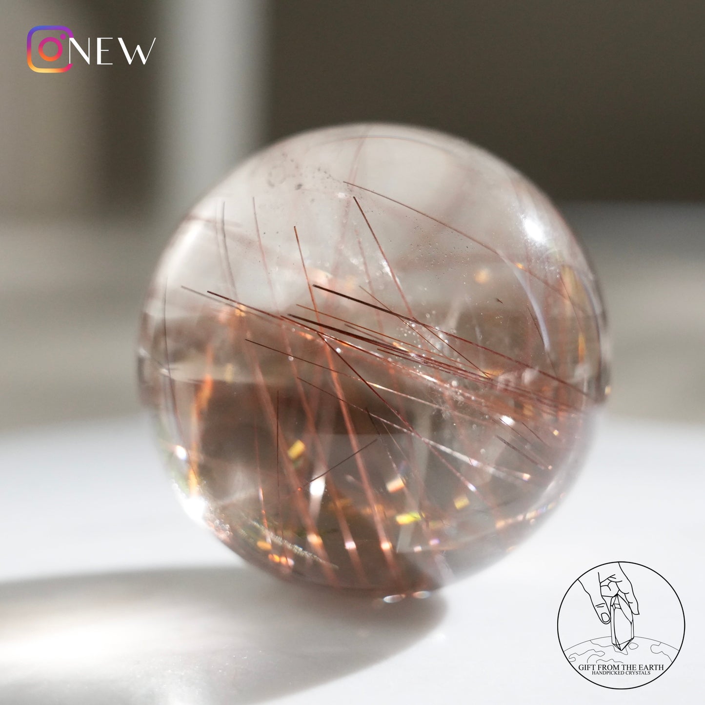 Red rutilated quartz sphere