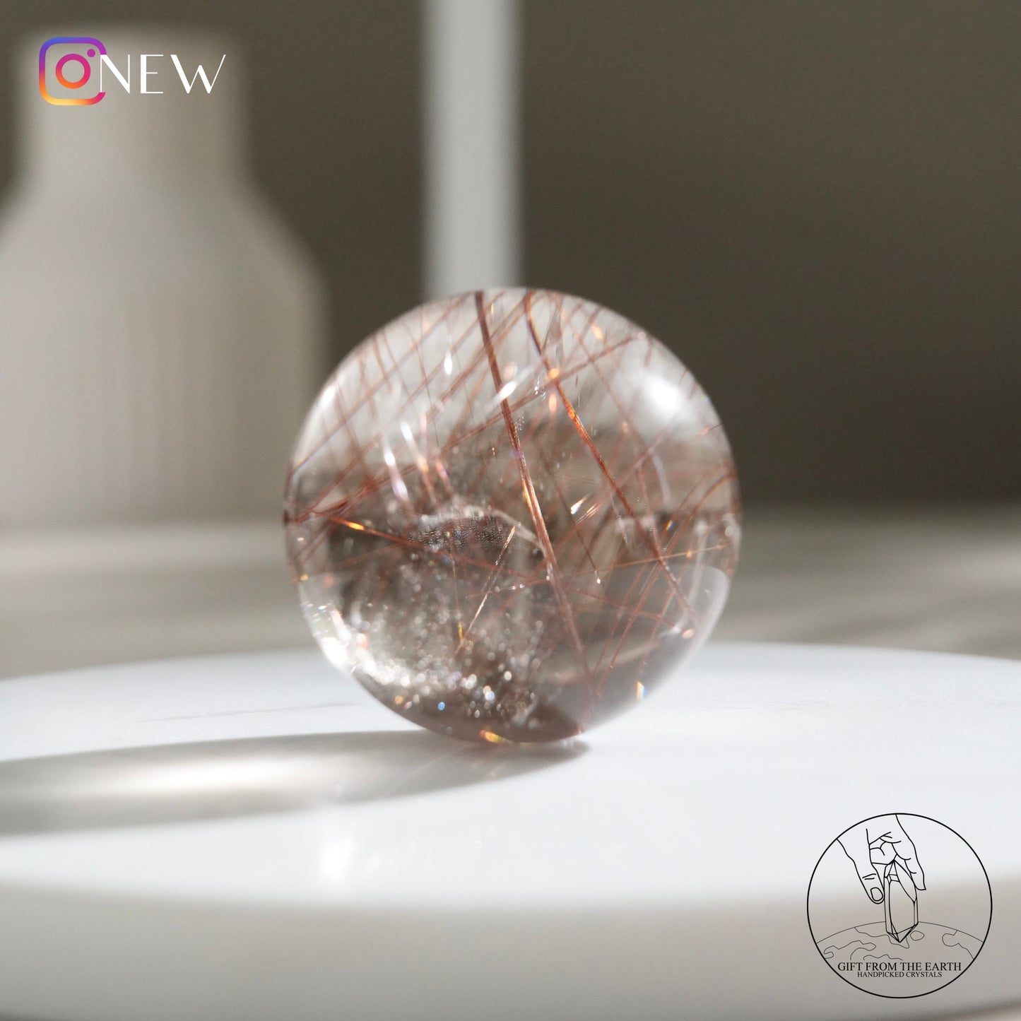 Red rutilated quartz sphere