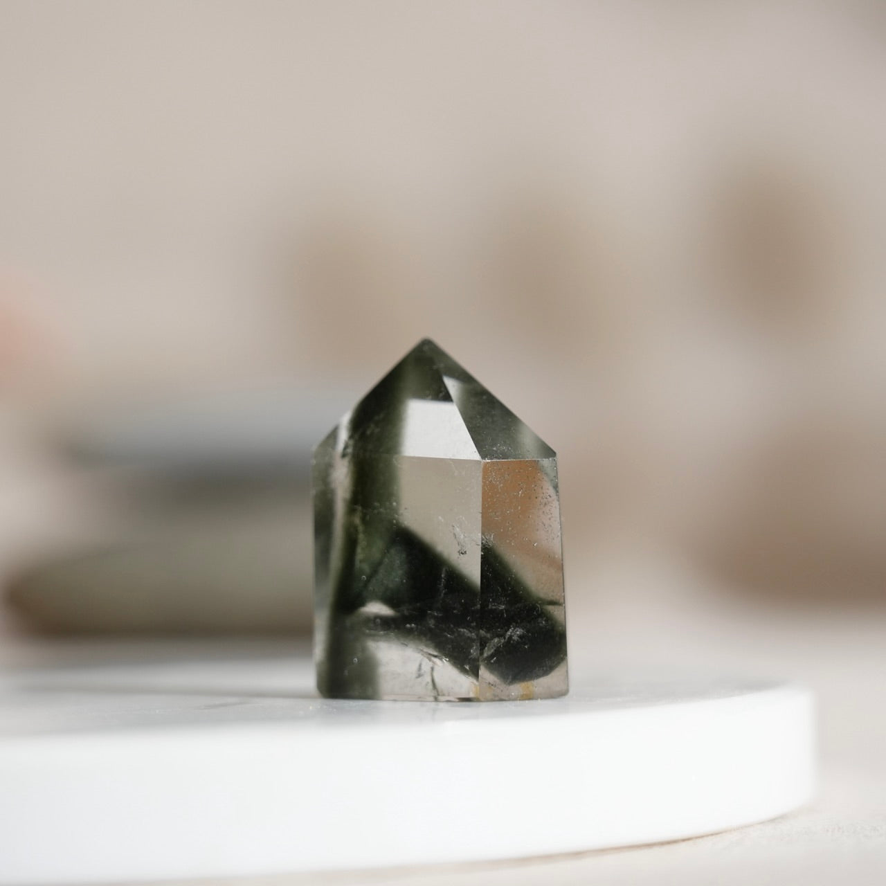 Half-polished multi-layered red-green phantom quartz point