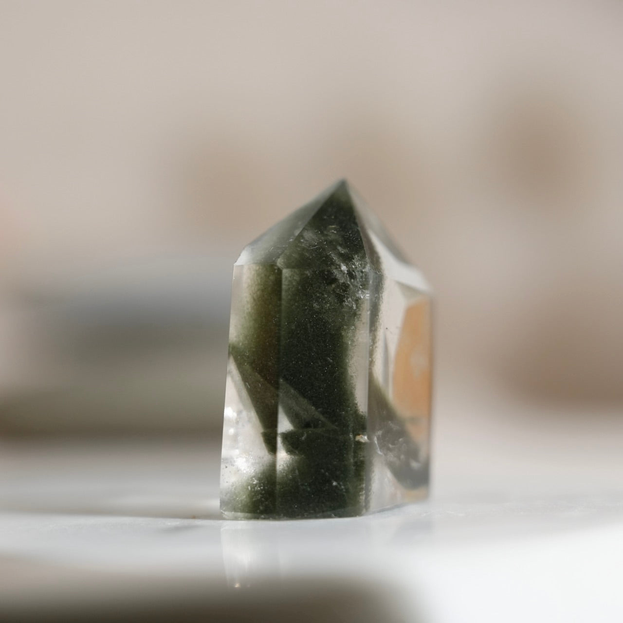 Half-polished multi-layered red-green phantom quartz point