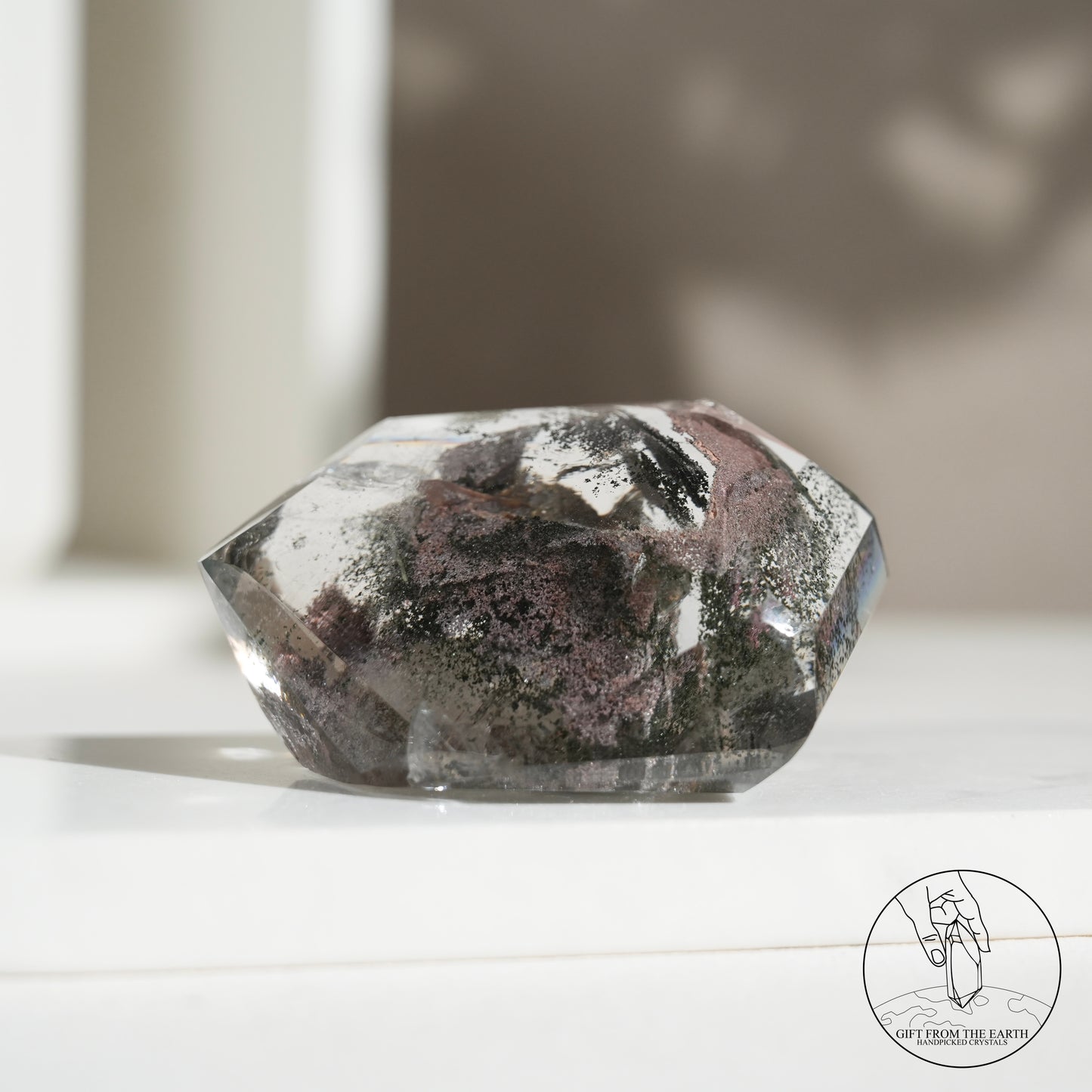 Half-polished multi-layered red-green phantom quartz point